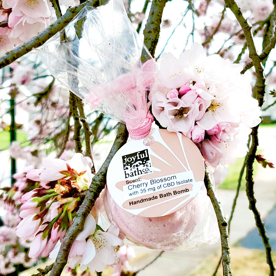 Cherry Blossom Hemp Bath Bomb hanging on a cherry blossom tree branch