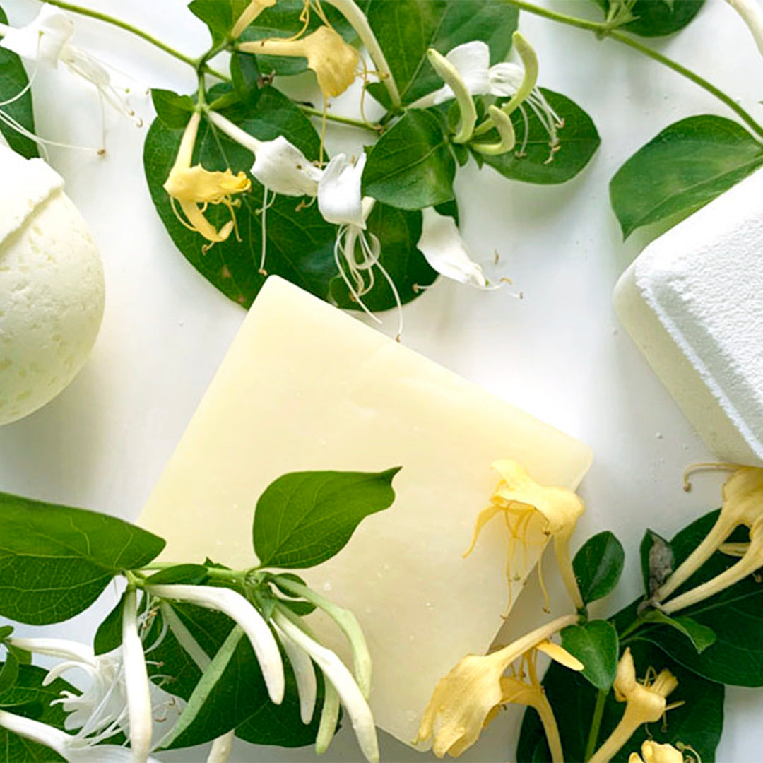 Honeysuckle Soap surround by honeysuckle plants