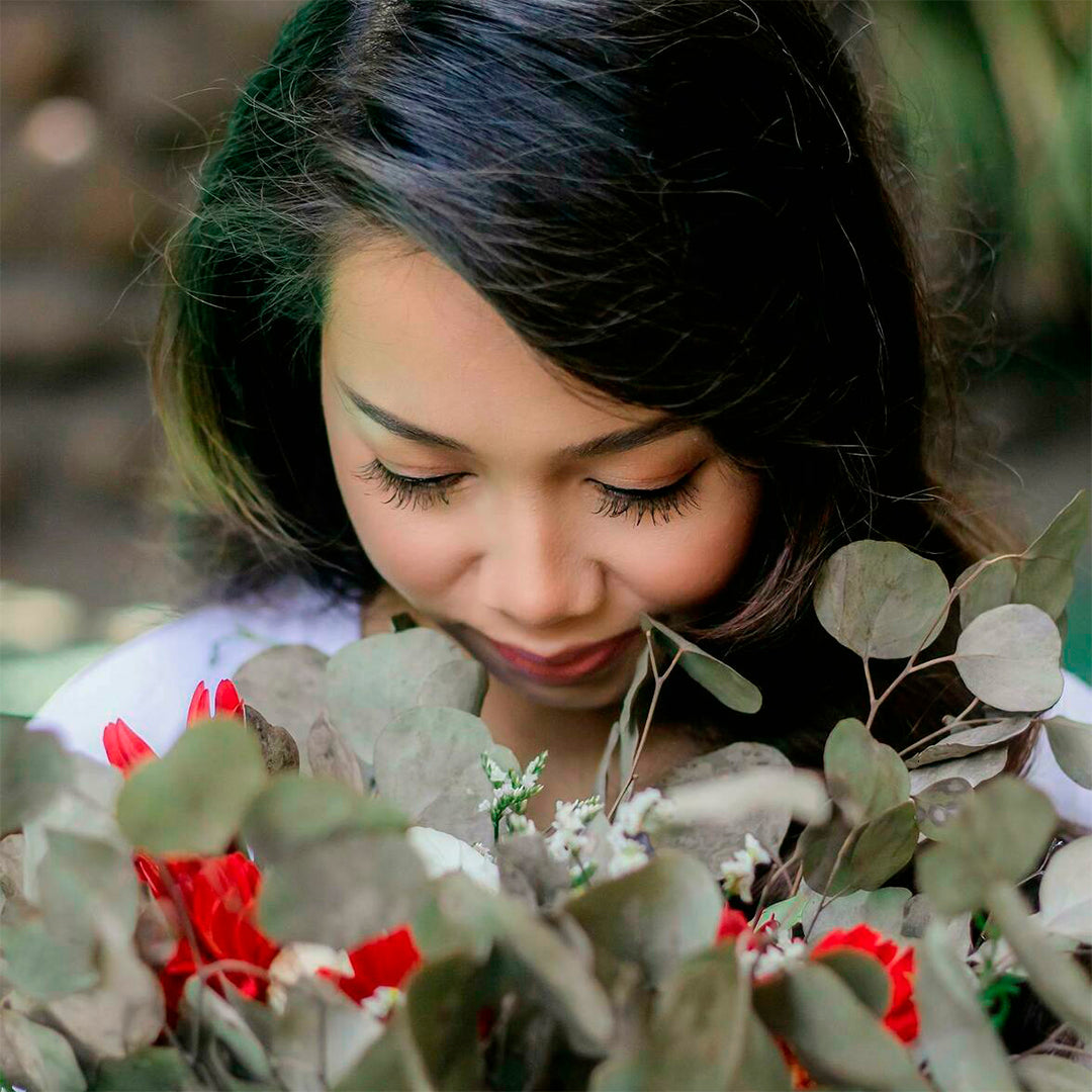 Woman chin down and smelling the scent of eucalyptus