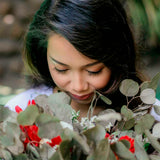 Woman chin down and smelling the scent of eucalyptus