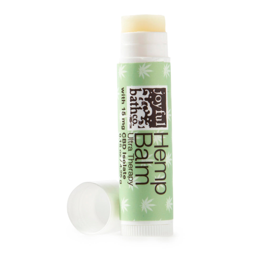a lip-tube of Hemp Balm with the cap off on a white background
