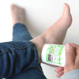 Hemp Balm on a stick is applied to a woman's foot