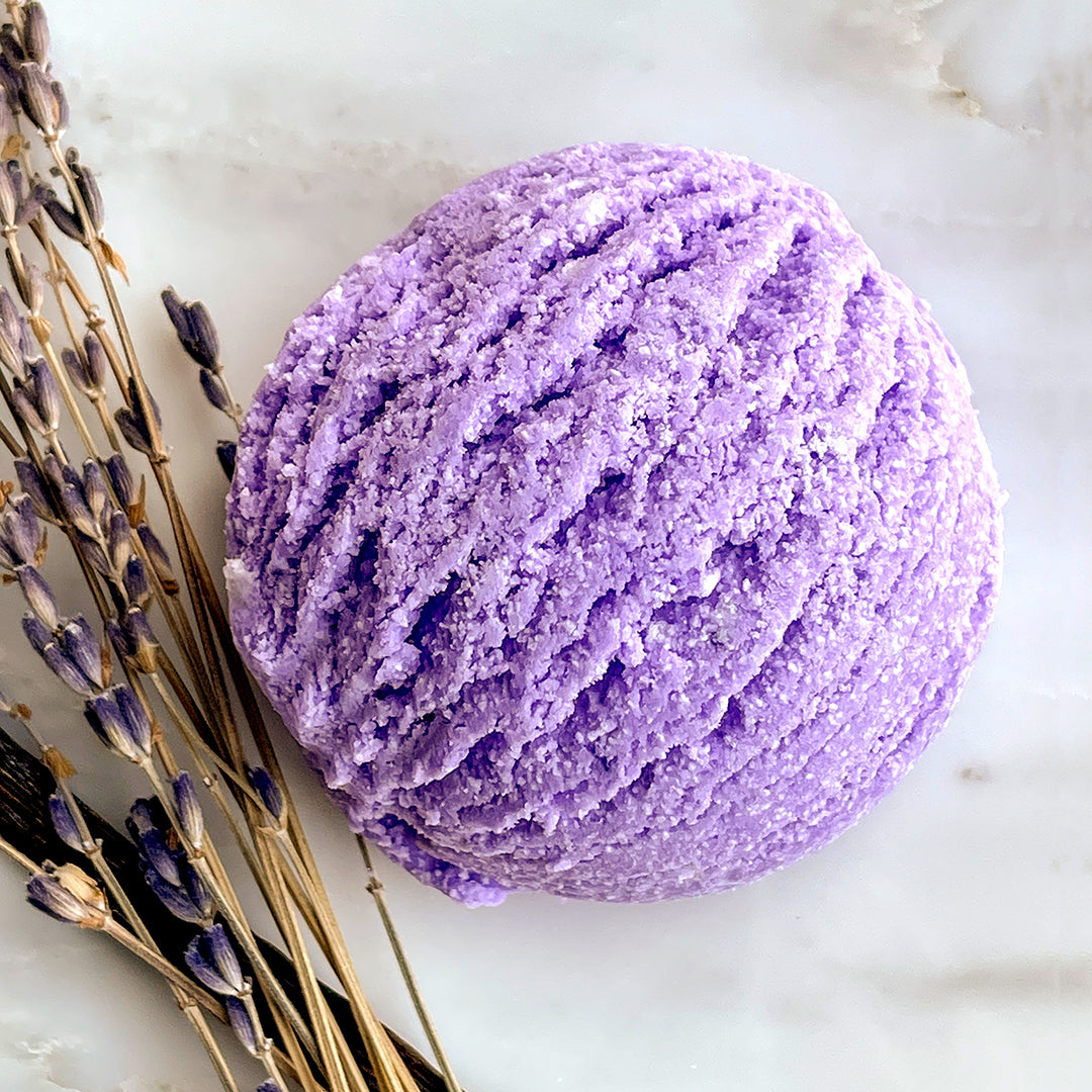 Lavender Vanilla Bubble Bath Scoop with dried lavender and vanilla beans in the foreground