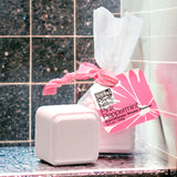 Pink Peppermint Shower Steamer on a granite shelf and tiled background