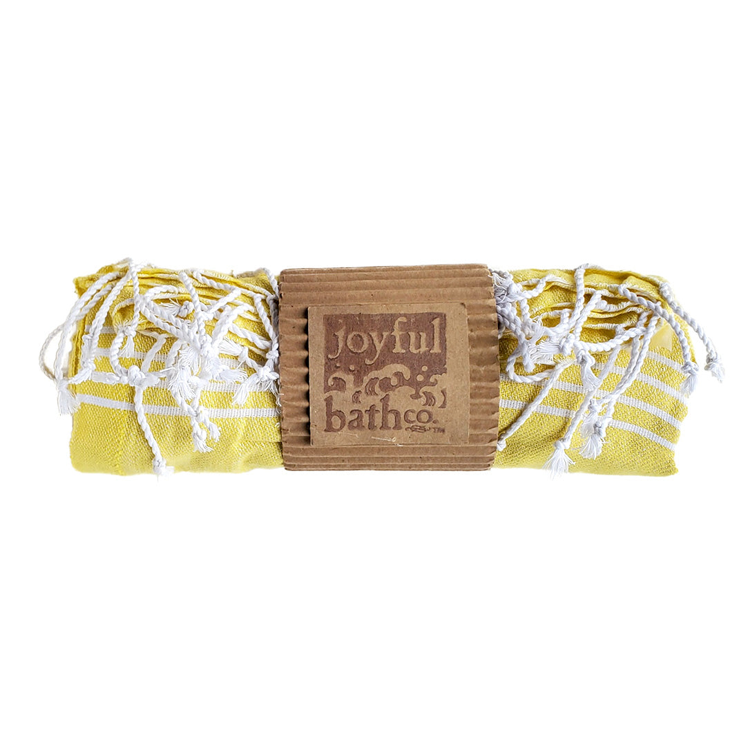 Turkish Towel in yellow all rolled up with Joyful Bath Co logo