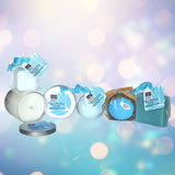 Bokeh image showing the contents of Total Bliss, a soy candle, shower steamer, bath bomb bubble bath scoop and soap with a slight blue and purple background color
