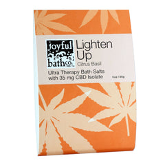 Lighten Up Citrus Basil Hemp Bath Salts in an orange packet on a white background